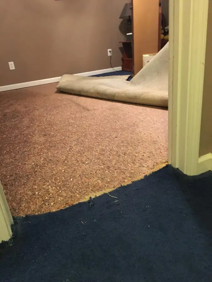 Carpet pad removal revealing water damage during Water Mitigation Services in Granbury